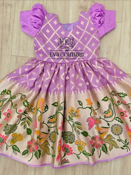 A one-piece frock with a unique Paithani and Kalamkari print combination. The bodice has a diamond pattern, and the skirt features colorful birds and flowers.