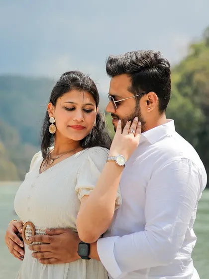 An intimate close-up of a couple by the river in Rishikesh, capturing a moment of quiet connection.