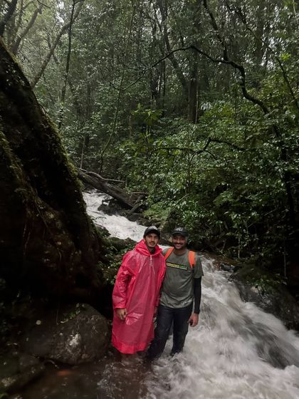 Two of our trekkers navigating a river crossing during the Kudremukha trek. Our experienced leaders ensure everyone crosses safely.