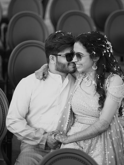A cool and happy black and white portrait of a couple wearing sunglasses. This candid shot captures their modern style and the joyful, relaxed vibe of their engagement session.