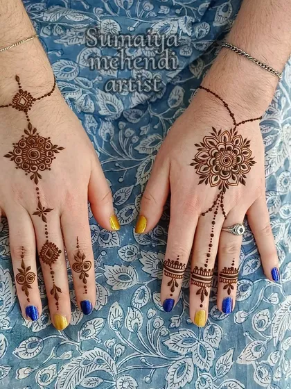 A beautiful and unique design for a wedding guest, with asymmetrical patterns on each hand.