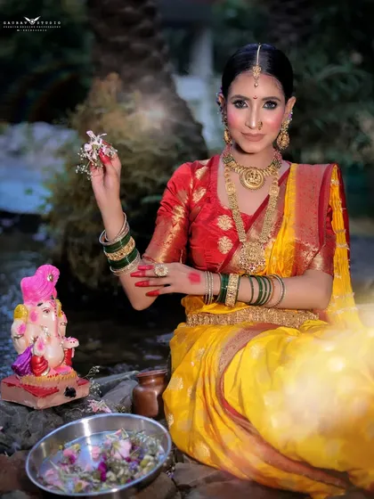 The model offers flowers to a Ganesha idol, her expression one of devotion in this culturally rich portrait.