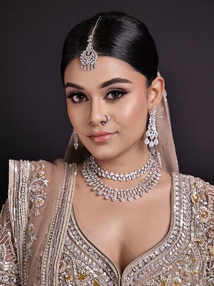 A close-up of the minimal bride. Her makeup is subtle yet impactful, with a focus on a flawless complexion and perfectly groomed brows.