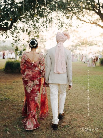 Walking away from the camera, hand in hand, into the golden light. This is a portrait of a shared future, a quiet and hopeful moment at the end of their ceremony.