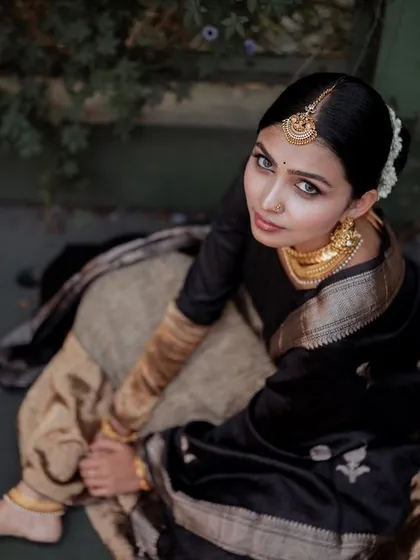 We captured this high-angle shot to emphasize the beautiful drape and texture of this heritage lehenga. The moody, natural lighting adds a touch of drama, creating an editorial feel perfect for a high-fashion lookbook in Bangalore. This is how we tell a story with clothing.