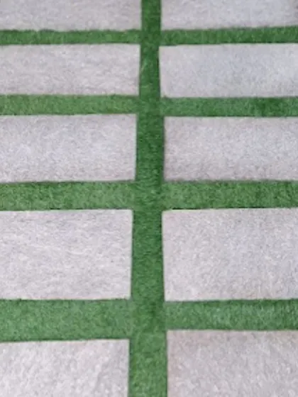 A very popular and modern design is combining artificial grass with natural stone pavers. This creates a durable and stylish pathway that is perfect for garden walkways or entrance areas.