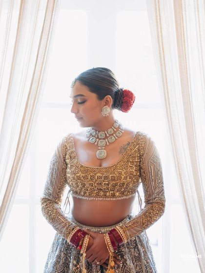 A quiet, reflective moment. This shot highlights the clean lines of her hairstyle and the beautiful shimmer of her blouse.