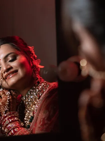 A creative shot of this royal bride. Her smile and the reflection in the mirror capture the happiness and excitement of the moment.
