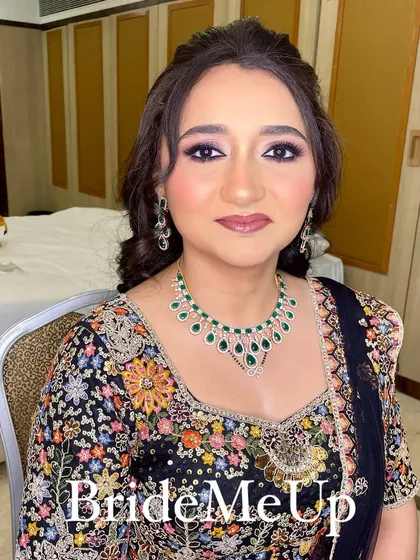 A front-facing portrait of Amita, looking radiant and happy. Her makeup is glamorous with a focus on the eyes.
