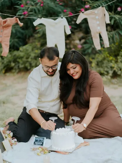 The moment of truth. The couple cuts into the gender reveal cake together, a highlight of this exciting and emotional photoshoot.