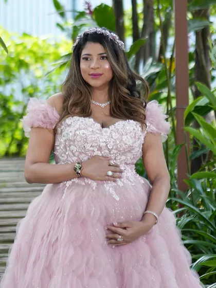 A beautiful portrait of the mom-to-be, cradling her bump. The soft, natural lighting and glowing makeup perfectly capture the serenity and beauty of this special time.