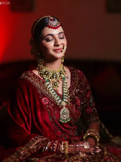 A quiet moment of reflection for the bride before she walks down the aisle. I used dramatic lighting to highlight the richness of her velvet lehenga and the artistry of her bridal look, creating a timeless and emotional portrait.