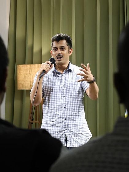 A performer shares his story with the audience in our cozy event space.
