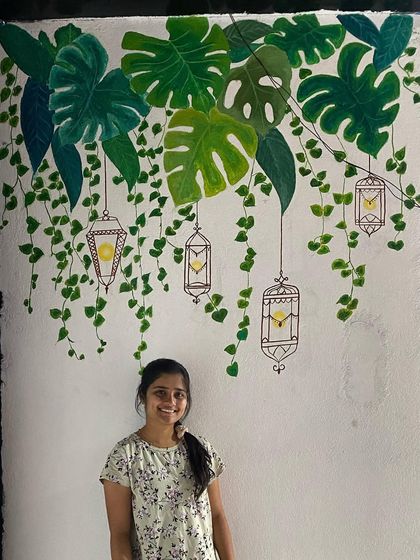 We love painting different styles of tropical murals. This one features hanging monstera leaves and floral creepers, creating a delicate and airy feel on the wall of a restaurant.