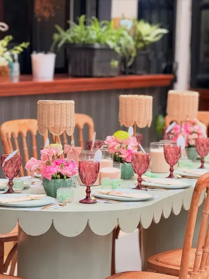 The beauty of an event is in the details. This tablescape from a Parisian baby shower features a scalloped-edge table, custom floral arrangements, and carefully chosen glassware, showing my passion for creating a complete and beautiful dining experience.
