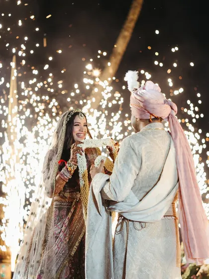 The magic of cold pyro. I love timing special effects like these sparklers to highlight the most emotional moments, like the exchange of garlands, making the memory even more special for the couple and their guests.