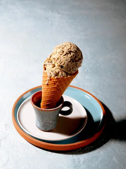 A moody, experimental shot of an ice cream cone. The unique styling and lighting create an artistic and memorable image that stands out from typical dessert photography.