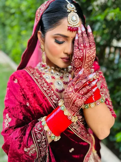 A close up pose of the bride, highlighting the beautiful, dark stain of her traditional bridal mehndi.