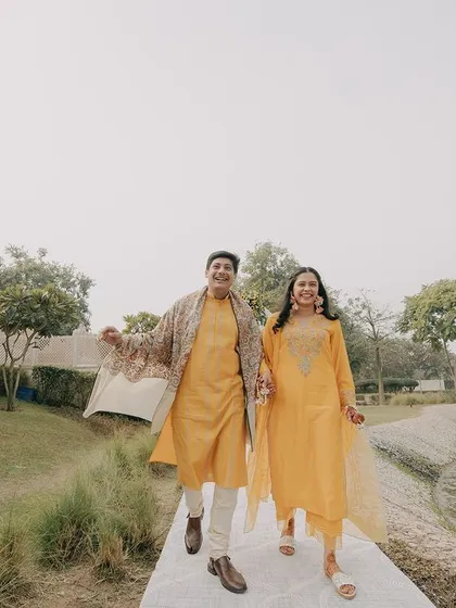 A fun and energetic shot of the couple. Their joyful stride along the water's edge captures the carefree and happy spirit of their pre-wedding celebrations.