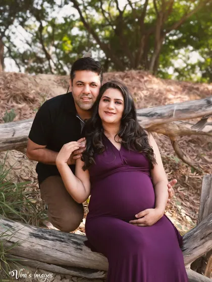 A lovely portrait of the couple seated together on a log. Their close and comfortable pose reflects their strong partnership.