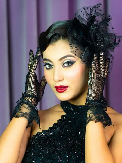 This pose highlights the delicate lace gloves and the dramatic eye makeup. It's a celebration of artistry, balance, and timeless beauty.