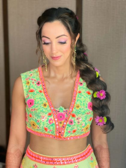 A beautiful portrait of the bride, her colorful floral braid adding a touch of whimsy and joy to her overall look.