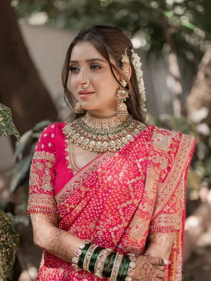 A closer look at this bride's soft and romantic makeup. The look is built around a flawless base, softly defined eyes, and a color palette that harmonizes with her pink saree.