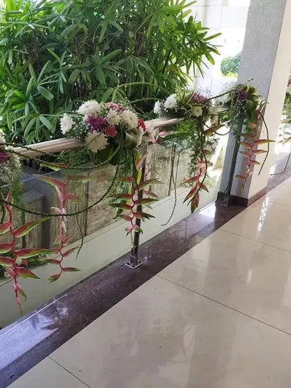 Another view of our floral railing decor for a home event. We use a mix of flowers like chrysanthemums and heliconia to create a lush, cascading effect along staircases and corridors.