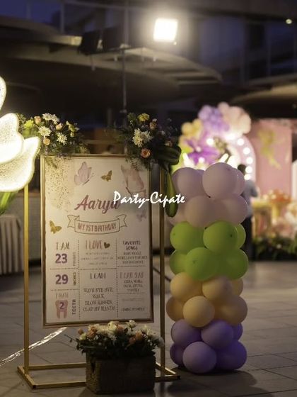 A personalized milestone board is a wonderful way to celebrate a first birthday. This one, framed by a beautiful floral light and balloon pillar, shared sweet facts about the birthday girl's first year.