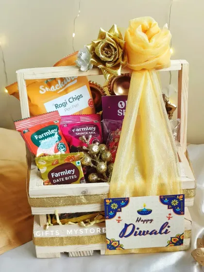 Our wooden crate hamper, beautifully wrapped and ready to go. The yellow net and floral decoration add a festive touch, making it a delightful gift to receive.