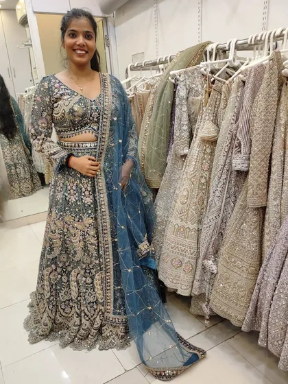 The client smiling, happy with her choice of rental lehenga.