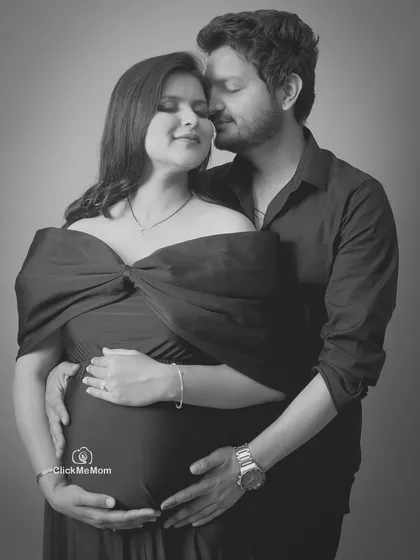 A tender embrace captured in a classic black and white portrait. Removing color allows the focus to fall entirely on the emotion and connection between the couple as they hold the baby bump together.