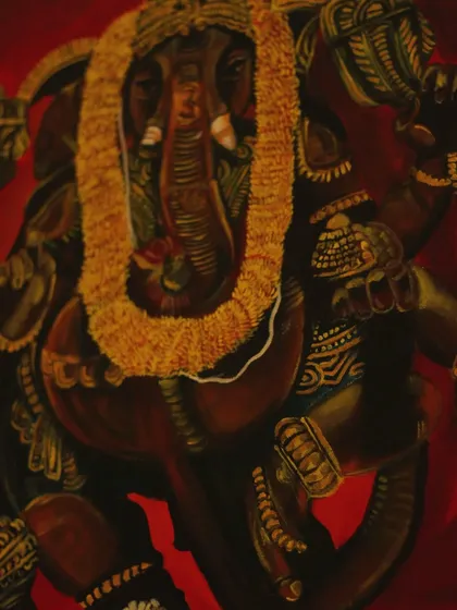A close-up of Lord Ganesha's face from the painting, focusing on the intricate details of his form and the textures of the garland.