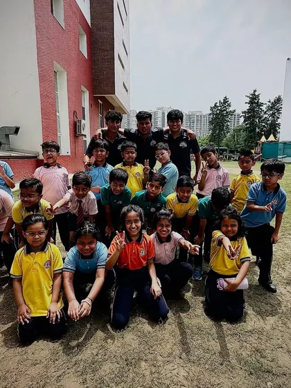 A happy group photo of young school kids with our coaches after a successful football workshop, marking the beginning of their football journey.