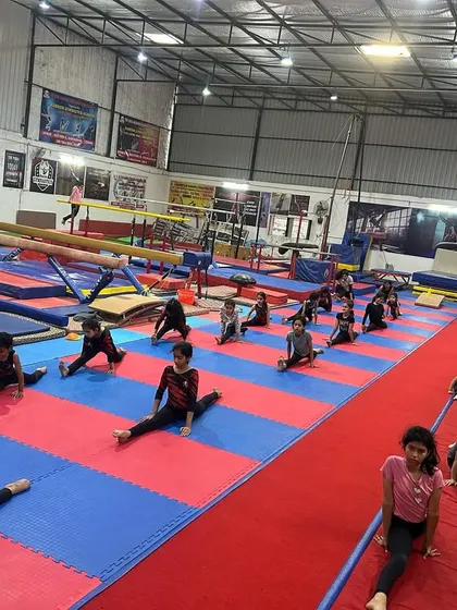 Discipline starts on day one. A typical scene at our academy with gymnasts working on their splits together. This synchronized group stretching builds not only flexibility but also the focus and unity of our team.