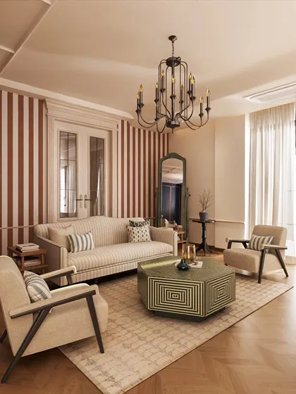 The lounge area within the master suite features a classic sofa set against a bold striped wallpaper. This contemporary touch contrasts beautifully with the room's neoclassical elements, showcasing our ability to balance different styles.