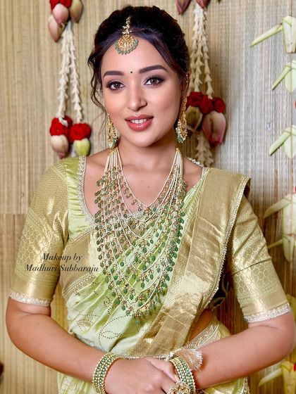 A beautiful close-up portrait showcasing the stunning multi-layered green bead necklace.