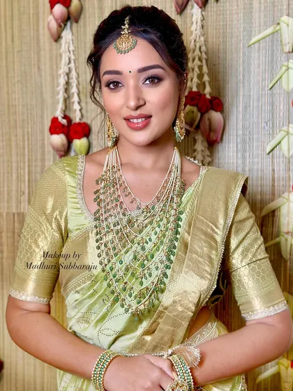 A beautiful close-up portrait showcasing the stunning multi-layered green bead necklace.