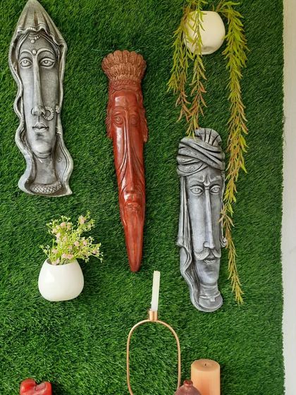 A detailed look at the tribal and ethnic wall masks used in the green balcony project. These pieces add a unique, artistic touch and serve as a great conversation starter, contrasting beautifully against the green backdrop.