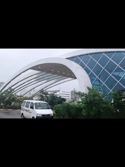 A ground-level shot of the entrance gate, emphasizing the smooth, curved canopy that provides shelter and creates a sense of arrival.