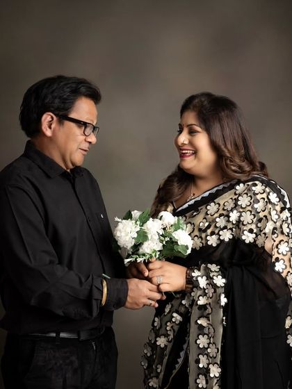 A beautiful portrait of a couple, likely celebrating a milestone anniversary together. This image captures their shared history and affection in a simple, elegant studio setting.