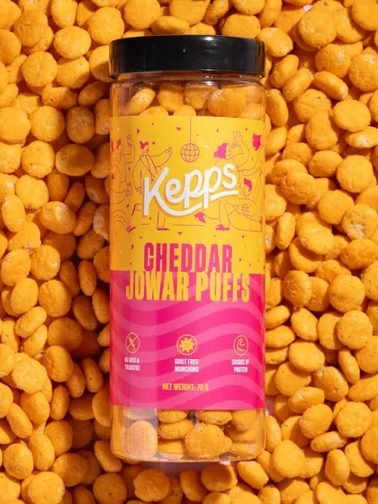 A full-frame texture shot like this is incredibly impactful. By completely surrounding the product with the cheddar puffs, we create a visually rich image that emphasizes the snack's flavor and crunchy texture.