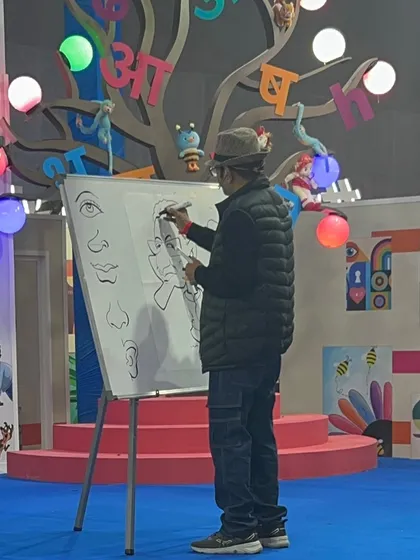 A shot of me demonstrating how to draw different facial features on the whiteboard during the workshop.