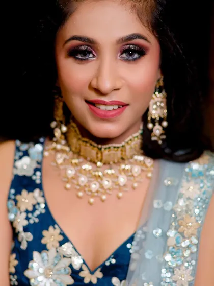 A happy, smiling close-up of the client, showing how the makeup and jewellery come together to create a radiant look.