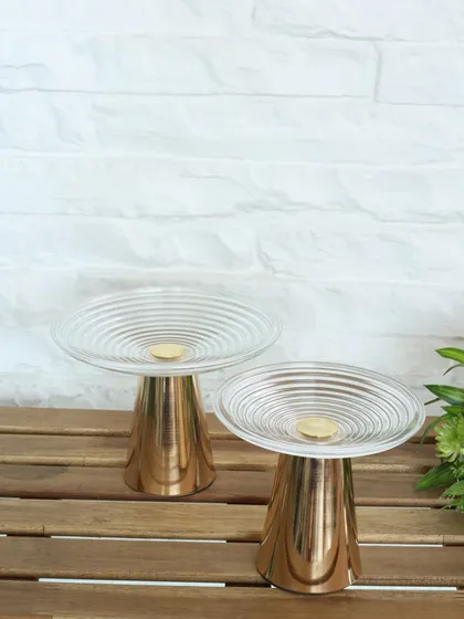 The Vesper high tea stand, featuring a rippled glass top and a polished gold base. Its modern, sculptural design is perfect for creating an indulgent and stylish tea-time experience.