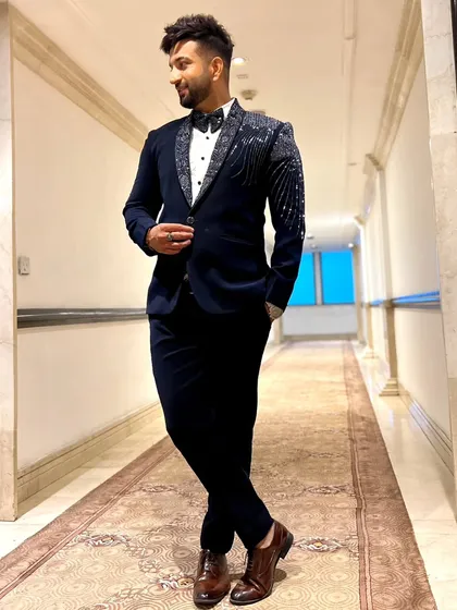 A client in a navy blue tuxedo with a uniquely patterned lapel. This is a great example of how we add a modern twist to classic formalwear.