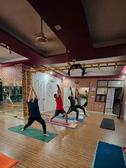 The energy of a group class is powerful. Here, our students move together through a warrior sequence, creating a shared focus and motivation that helps everyone push their limits.