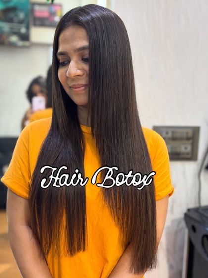 The final result of a Hair Botox treatment. The client's hair is visibly smoother, straighter, and has a healthy shine. This treatment is perfect for anyone struggling with unmanageable, frizzy hair.