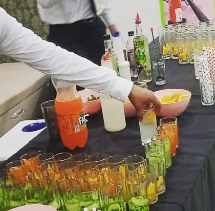 A close-up of my bartenders artfully preparing a line of colorful mocktails. Their skill and flair add an element of entertainment to the beverage service.