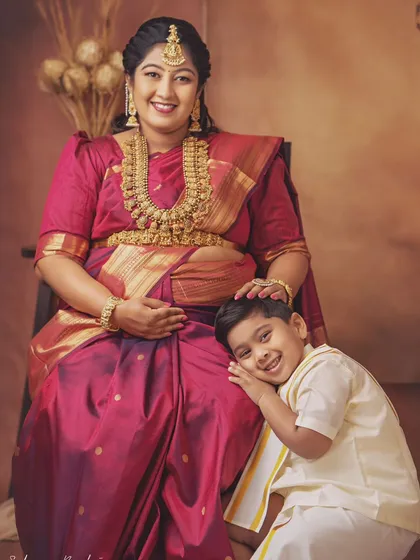 The bond between a mother and her child is so precious. Here, the older brother-to-be rests his head on his mother's lap, a sweet and tender moment as they wait for the new family member.
